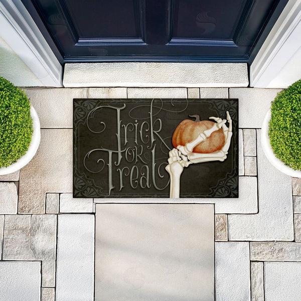 Stupell Industries Nicole Tamarin | Trick Or Treat Skeleton Hand Non-Woven Door Mat